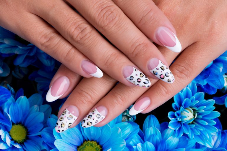 Beautiful woman's nails with beautiful french manicure and art design